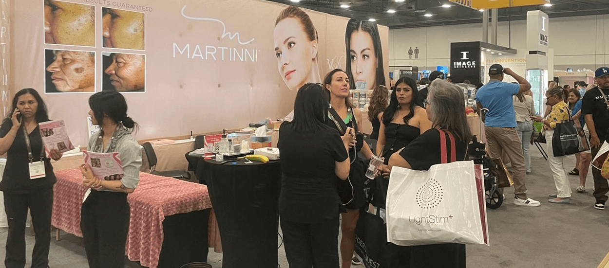 Elore tradeshow booth with team and guests at a beauty expo